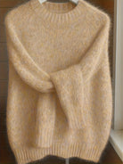 Front view of the Lila cashmere-blend sweater in a soft apricot color, showcasing its elegant drape.