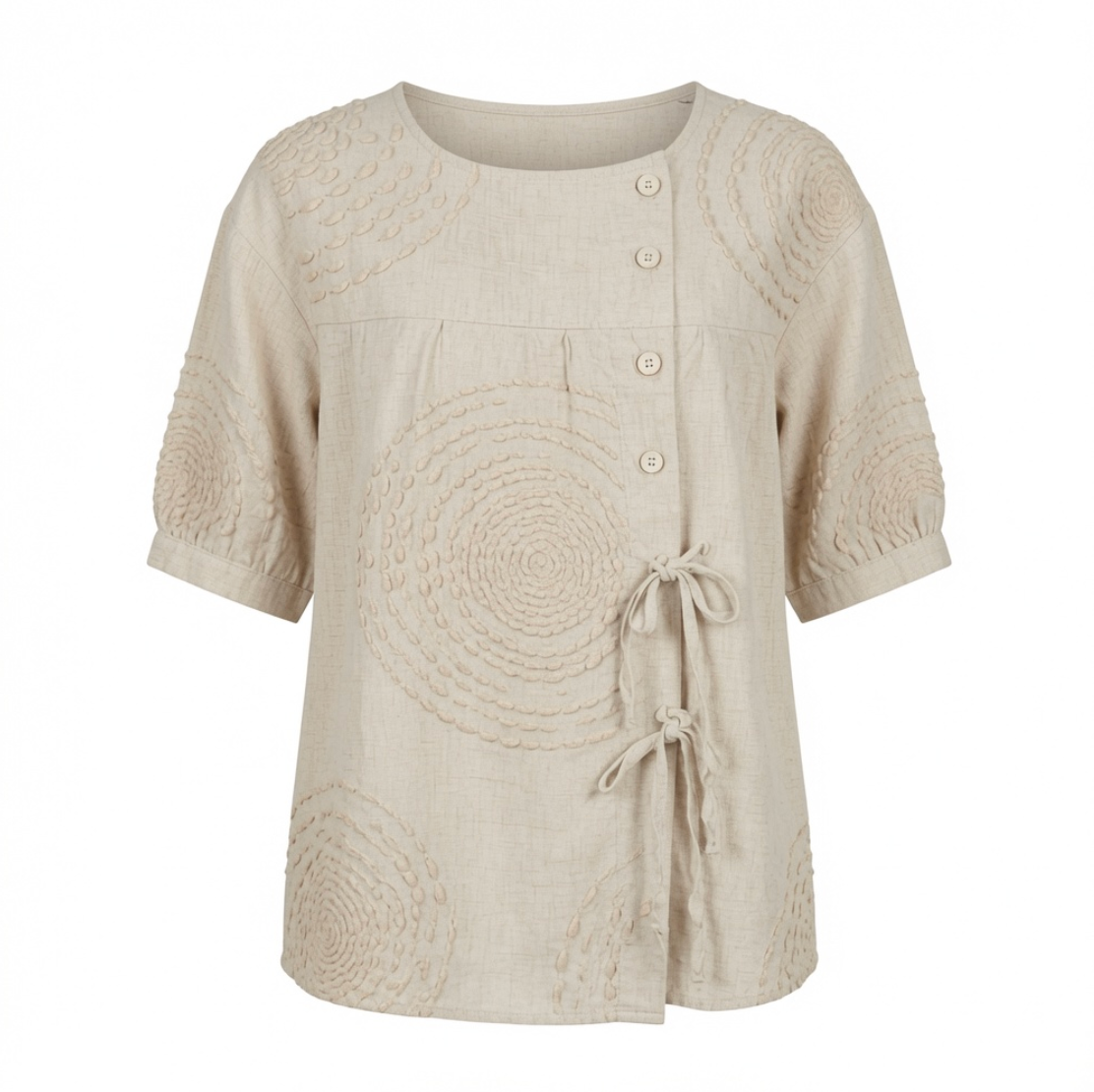 Close-up detail of the raised circular embroidery on the Calliope casual top, highlighting its intricate texture.