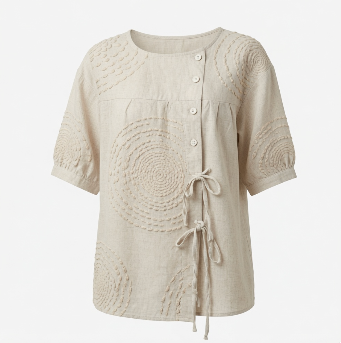 Side view of the Calliope embroidered top, demonstrating the adjustable drawstring tie at the hip for a custom fit.