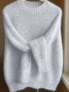 Side profile of a model wearing the light grey Lila cashmere-blend sweater, highlighting its flattering fit.