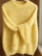 Detail of the cuff on the yellow Lila cashmere-blend sweater, showing the quality stitching and soft fabric.