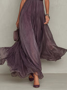 Lifestyle shot of the Lyra maxi dress in motion, illustrating its elegant flow and comfortable fit for spring events.