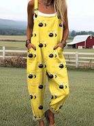Front view of the Marlowe whimsical bee jumpsuit in bright yellow with large cartoon bees, showcasing its relaxed fit and adjustable straps.