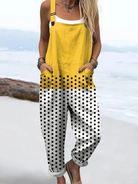 Front view of the Viviana polka dot jumpsuit, showcasing its vibrant yellow top fading to white with black dots, on a female model.