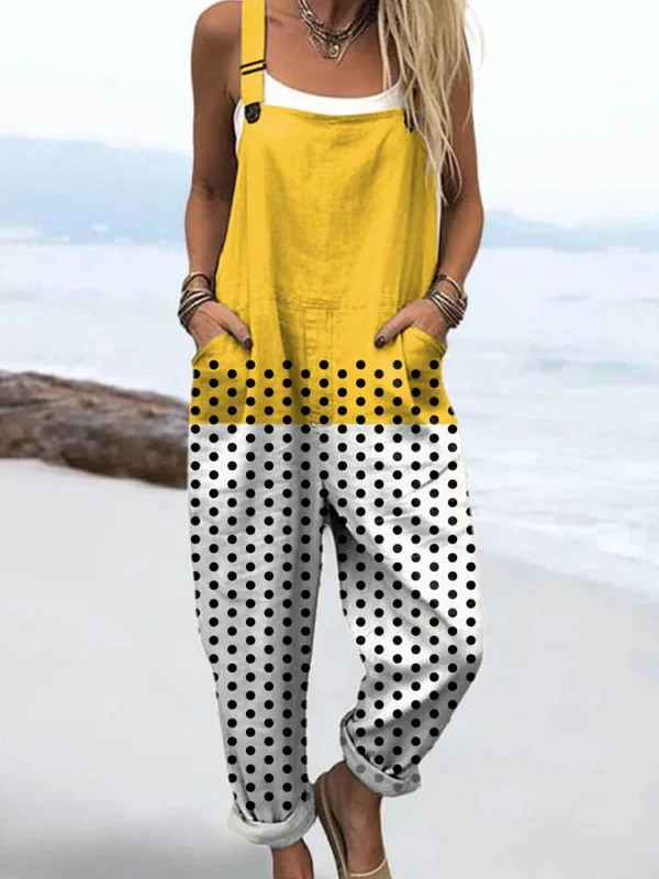 Front view of the Viviana polka dot jumpsuit, showcasing its vibrant yellow top fading to white with black dots, on a female model.