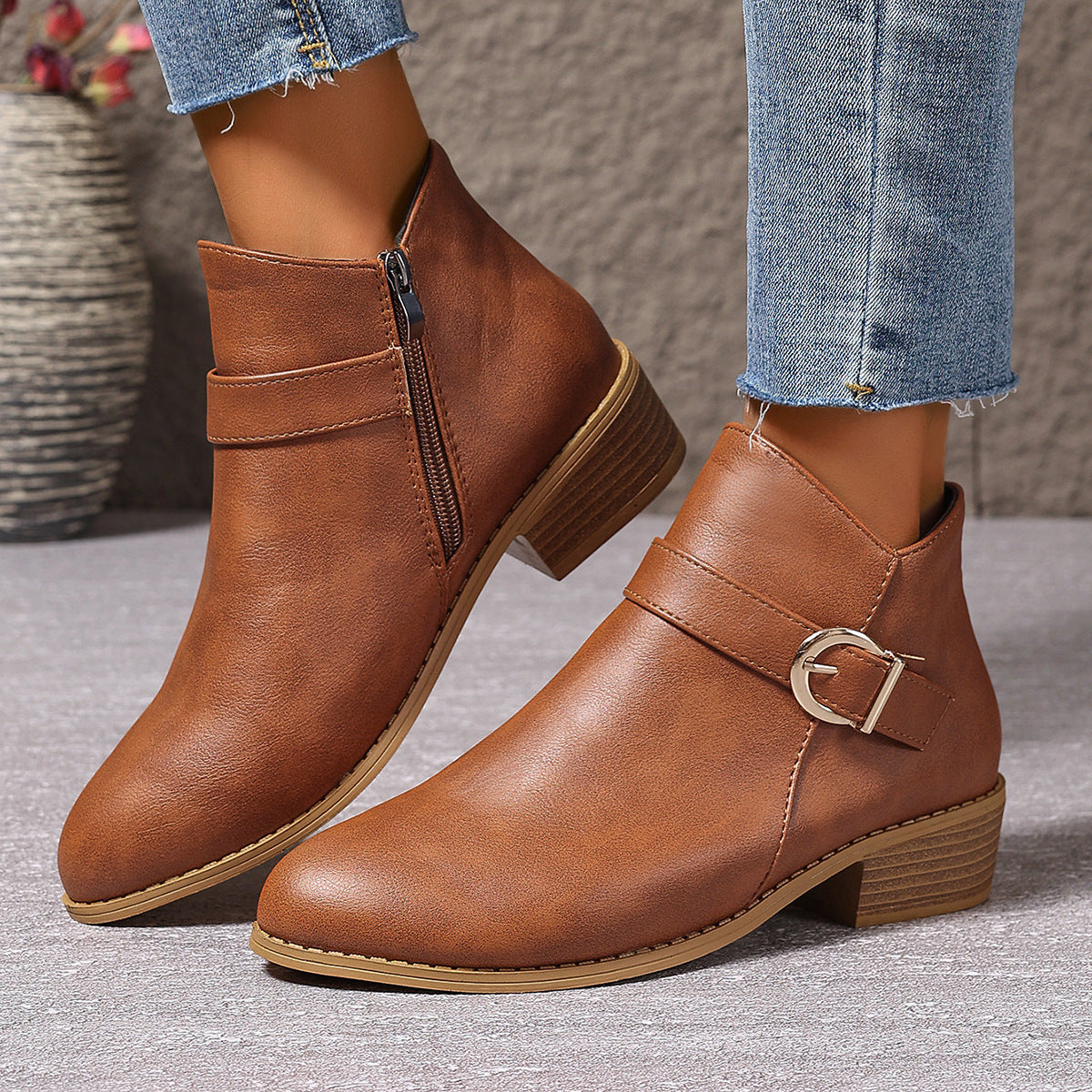 Side view of a brown Zara comfort ankle boot, showcasing its sleek silhouette and low heel.