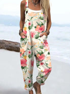 Front view of the Zephyra floral print jumpsuit in a light neutral base with pink and green watercolor flowers, styled on a model.